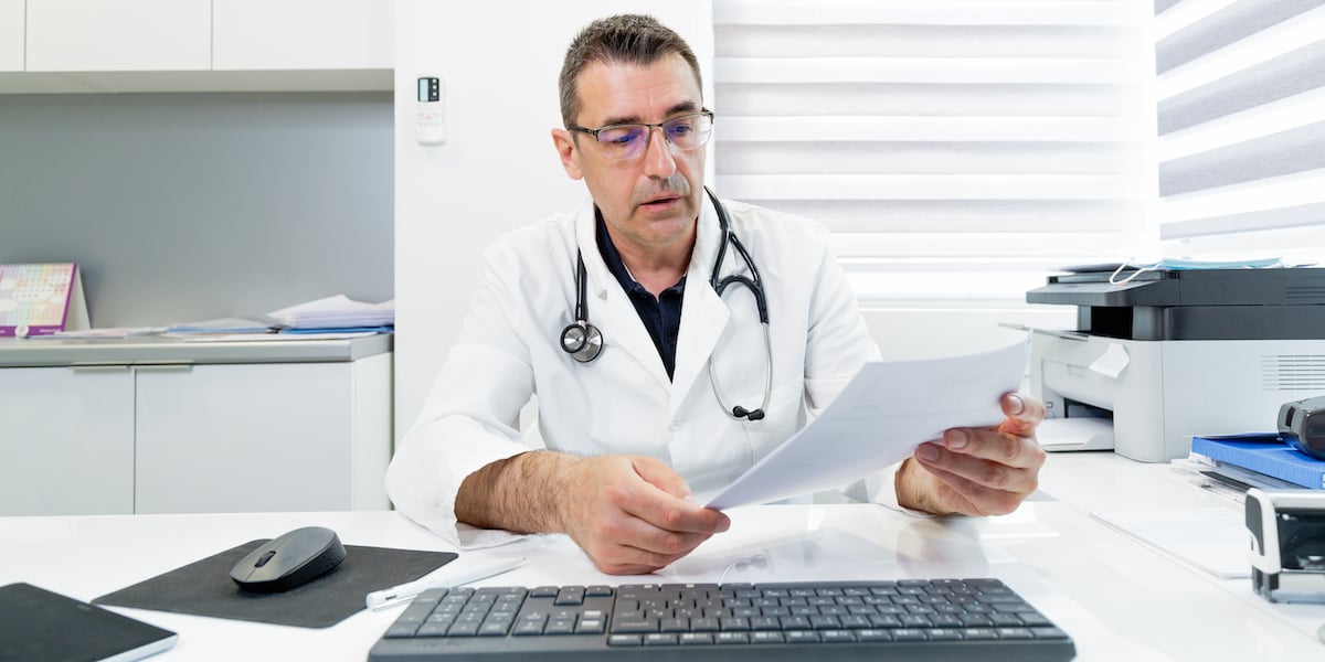 Doctor reading a pathology report