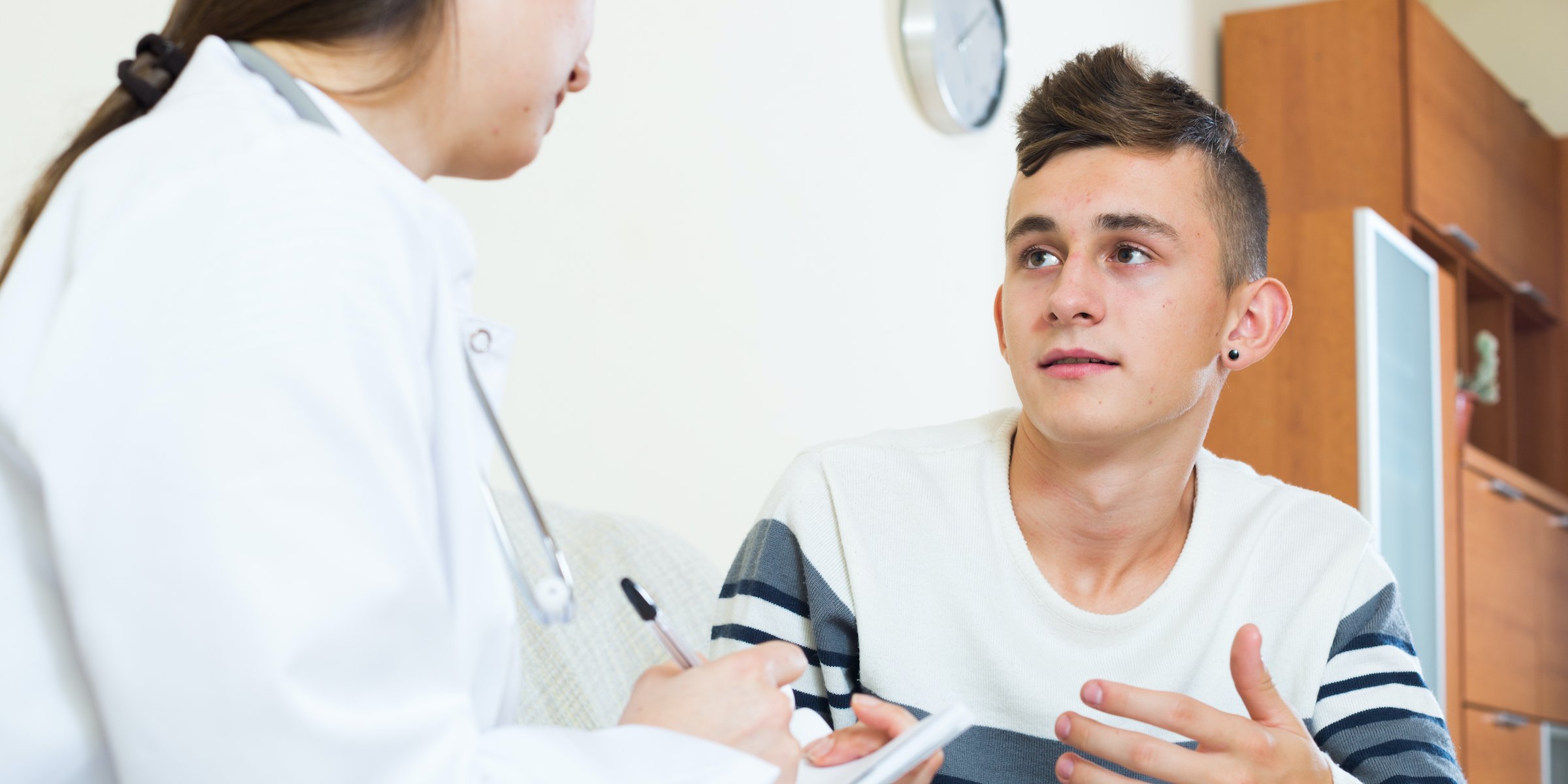 doctor examinating teen boy