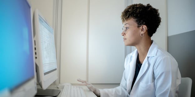doctor looking at a computer screen