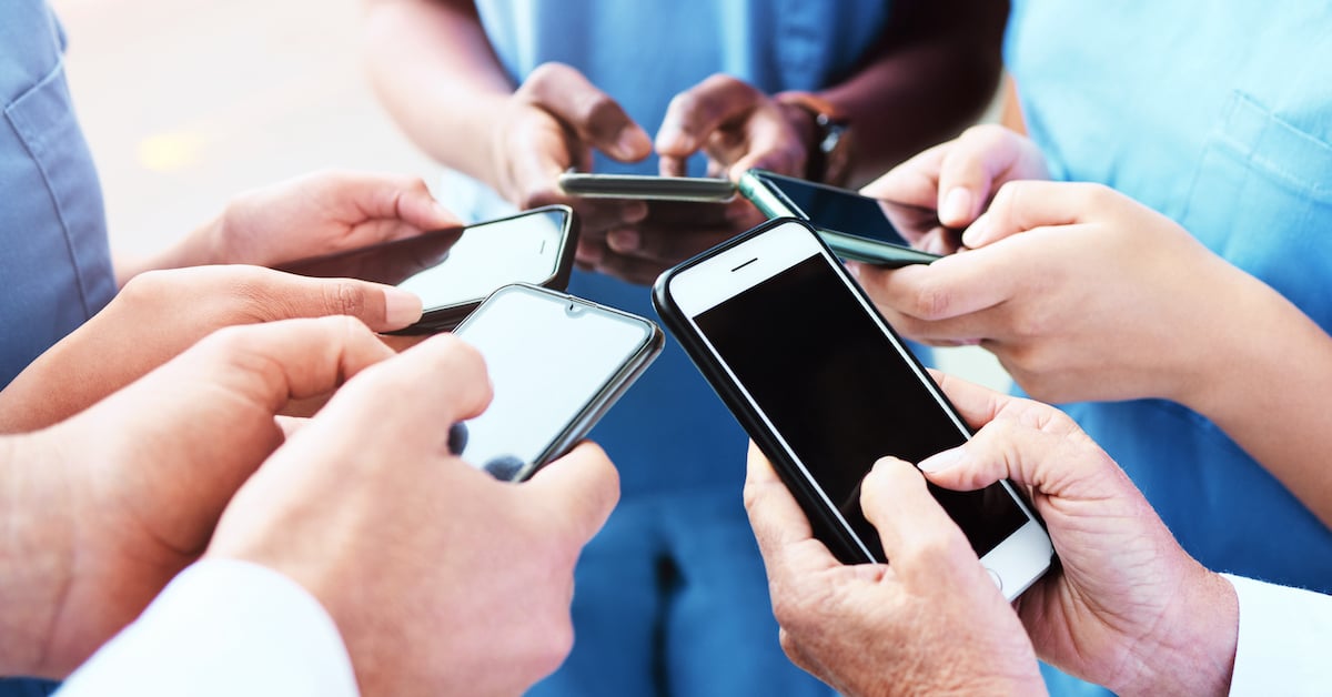 group of doctors texting at work