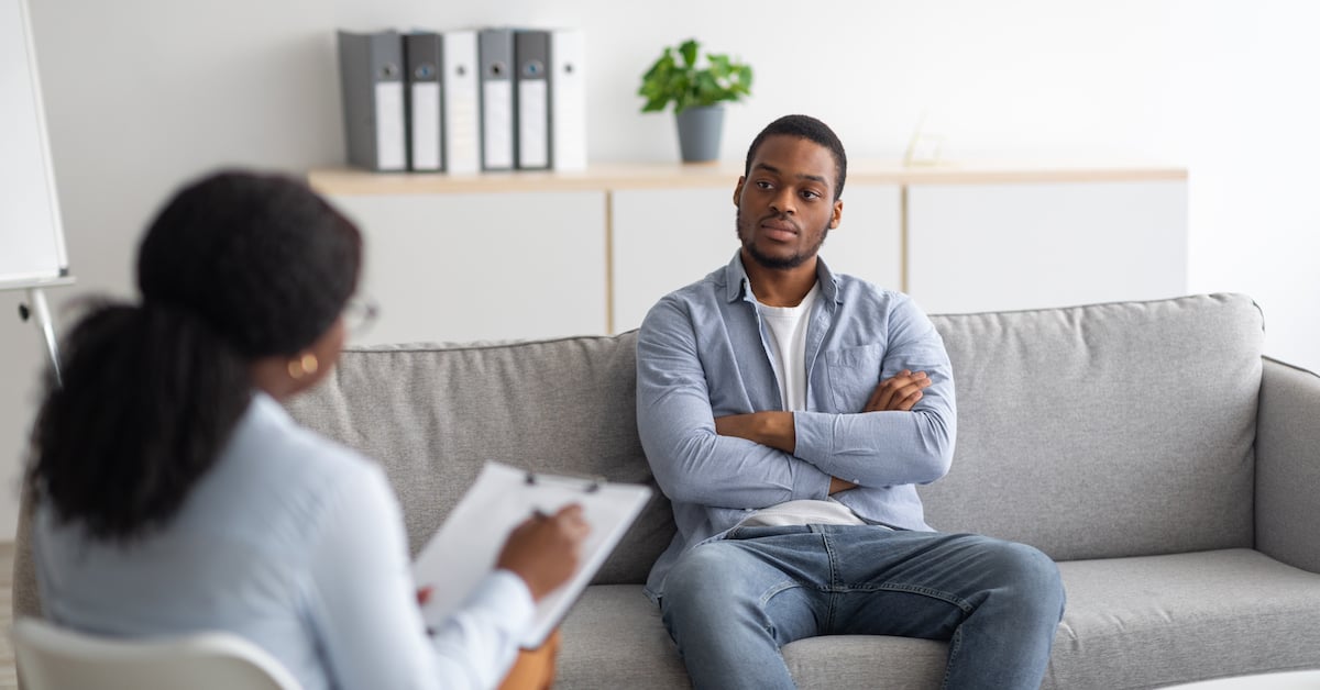 male-patient-with-depression-having-session-with-psychotherapist-at-office_soc