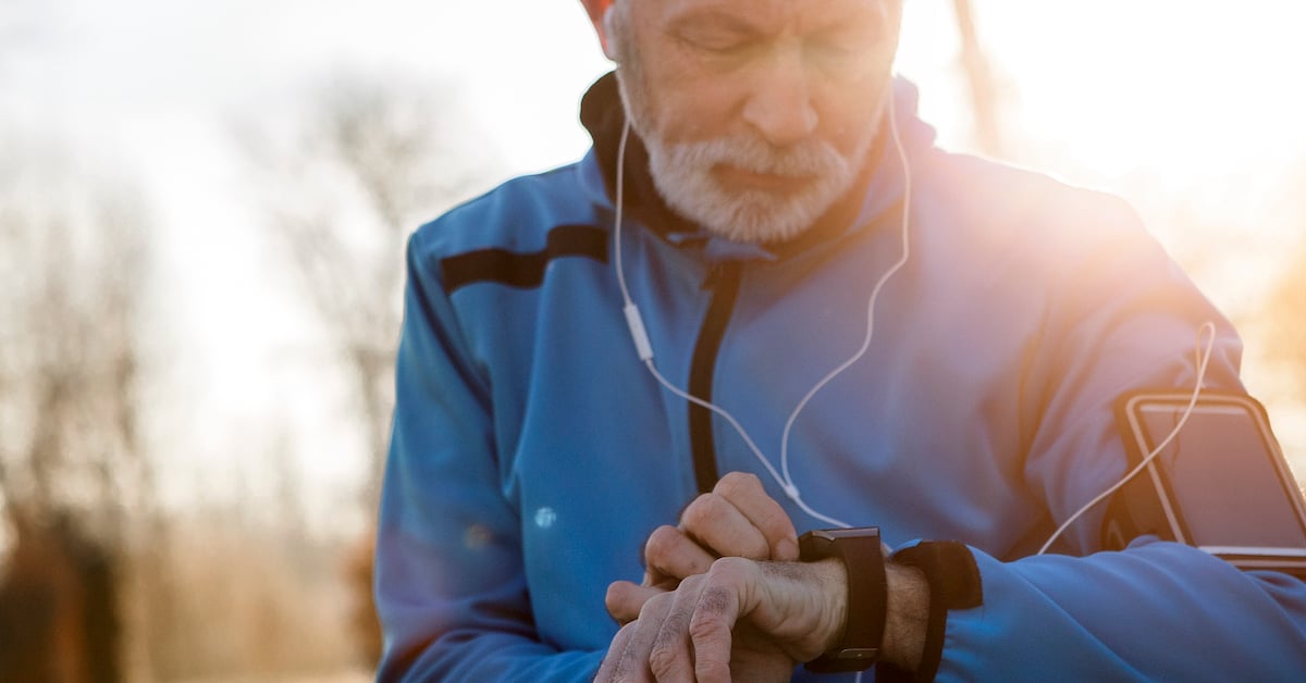senior man using an mhealth fitness wearable