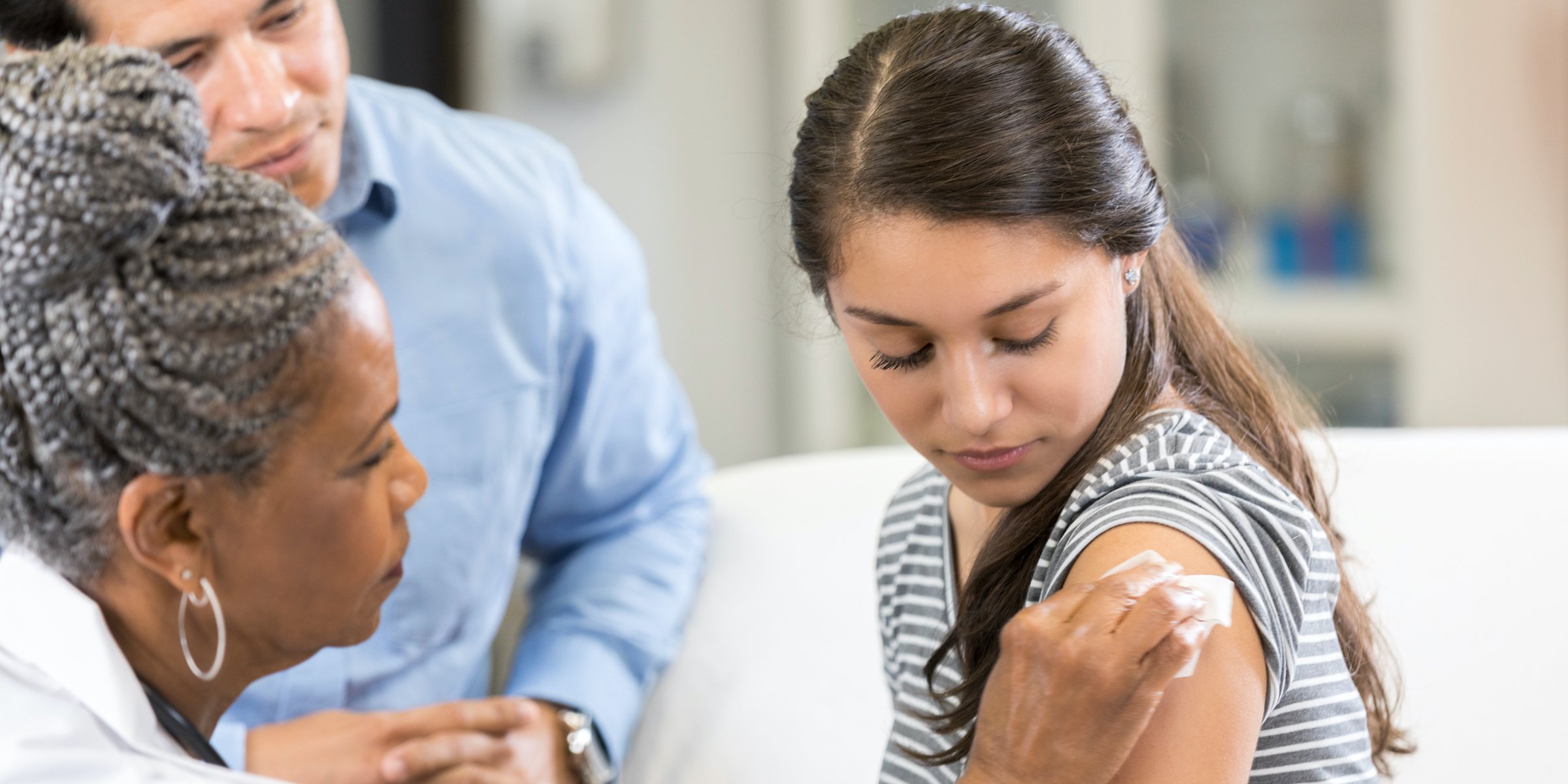 teenage girl prepares for vaccination