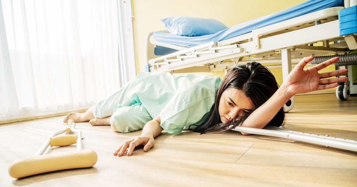 young woman lying on the floor at hospital after she fell